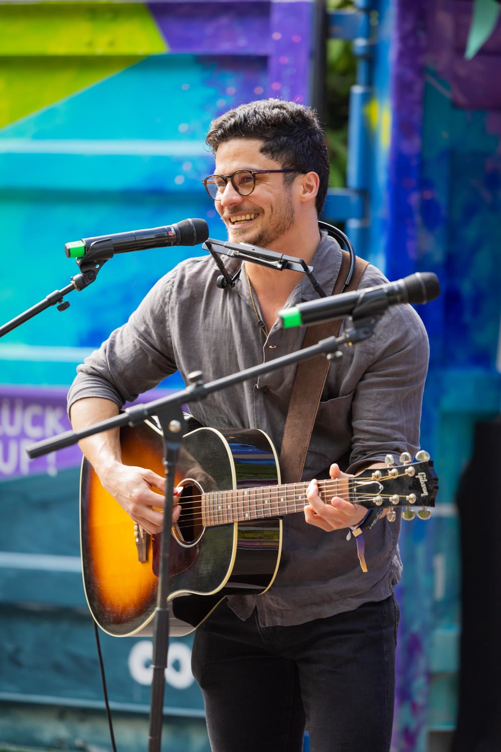 David Quirós playing guitar and singing at a live show